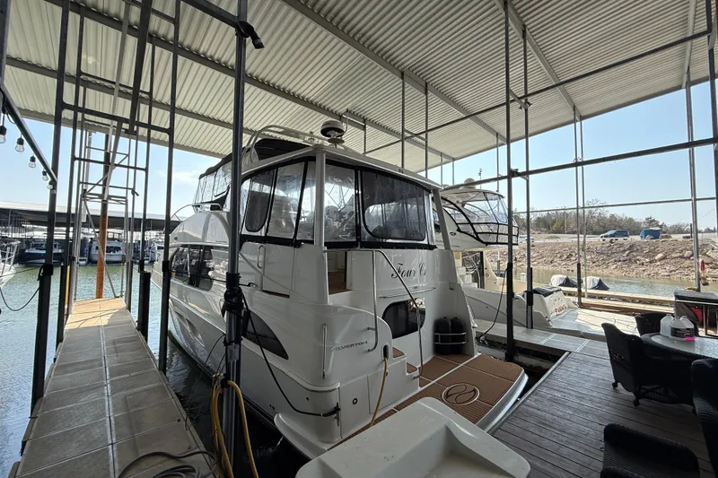 Slide: The Image of 2005 Silverton 43 Motor Yacht docked in a covered marina. - 11