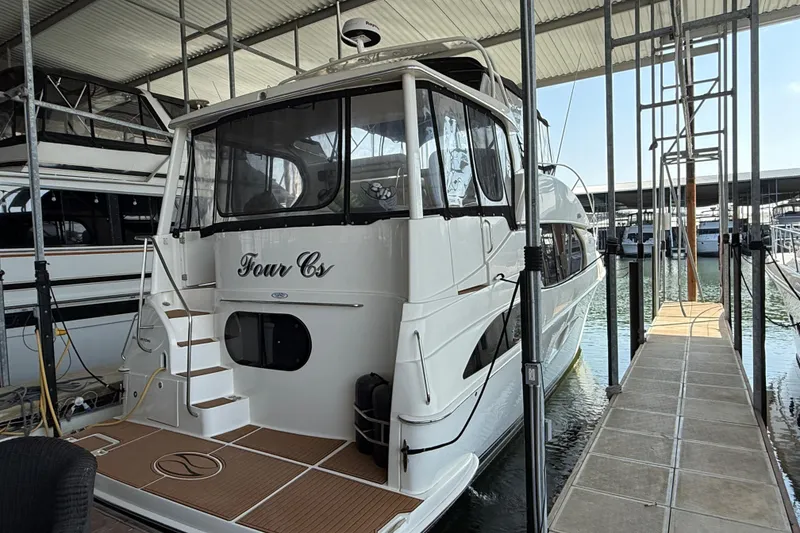 Slide: The Image of 2005 Silverton 43 Motor Yacht docked in a marina, rear view. - 12