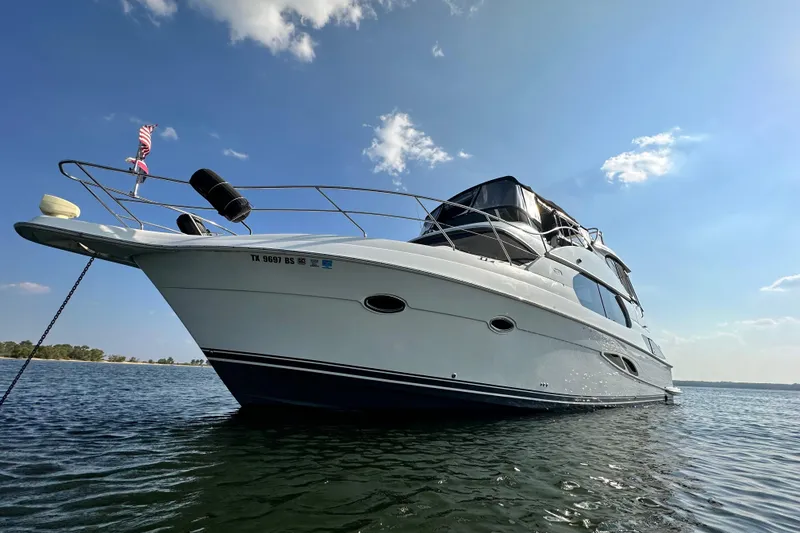 Slide: The Image of 2005 Silverton 43 Motor Yacht on calm water under clear blue sky. - 13