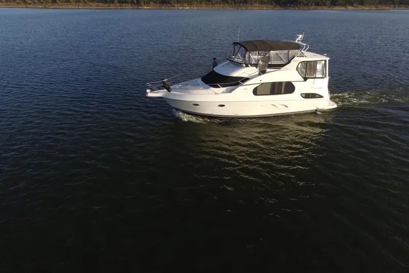 Slide: The Image of 2005 Silverton 43 Motor Yacht cruising on calm waters. - 16