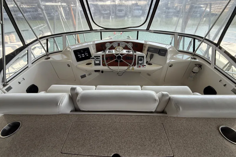 Slide: The Image of 2005 Silverton 43 Motor Yacht helm with modern controls and panoramic view. - 19