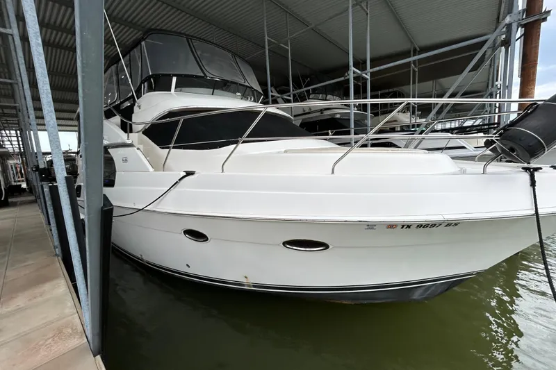 Slide: The Image of 2005 Silverton 43 Motor Yacht docked in a covered marina. - 2