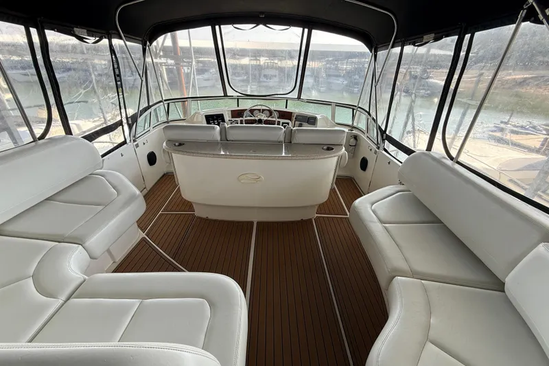 Slide: The Image of 2005 Silverton 43 Motor Yacht interior with white seating and wood flooring. - 20