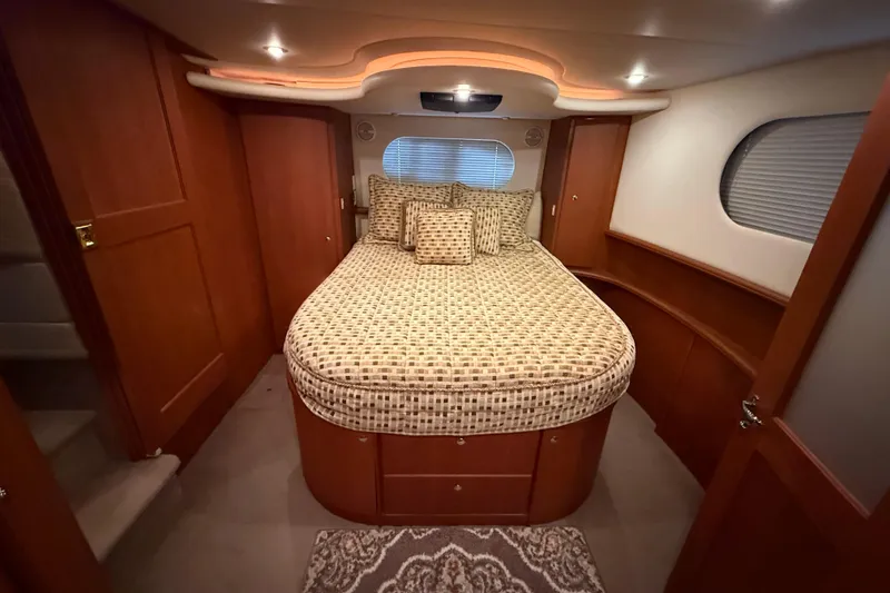 Slide: The Image of Luxurious bedroom interior of 2005 Silverton 43 Motor Yacht with elegant wood finish. - 23