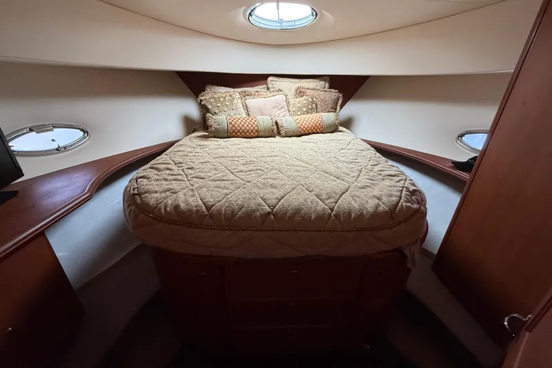 Slide: The Image of Luxurious bedroom interior of 2005 Silverton 43 Motor Yacht with plush bedding and porthole windows. - 27