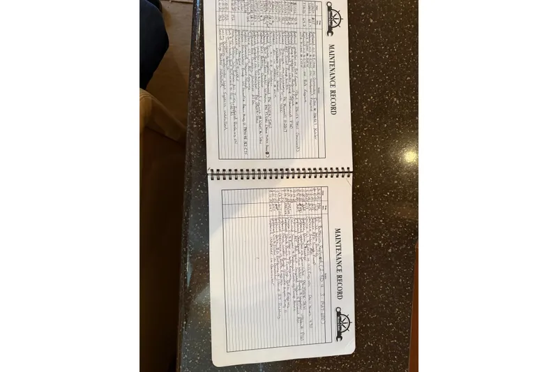 Slide: The Image of Open maintenance record book for 2005 Silverton 43 Motor Yacht on a table. - 33