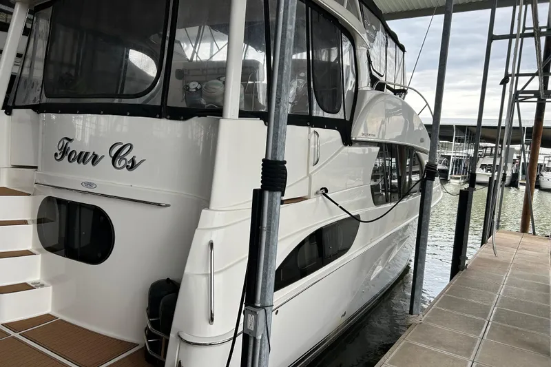 Slide: The Image of 2005 Silverton 43 Motor Yacht docked, featuring sleek design and spacious deck. - 4