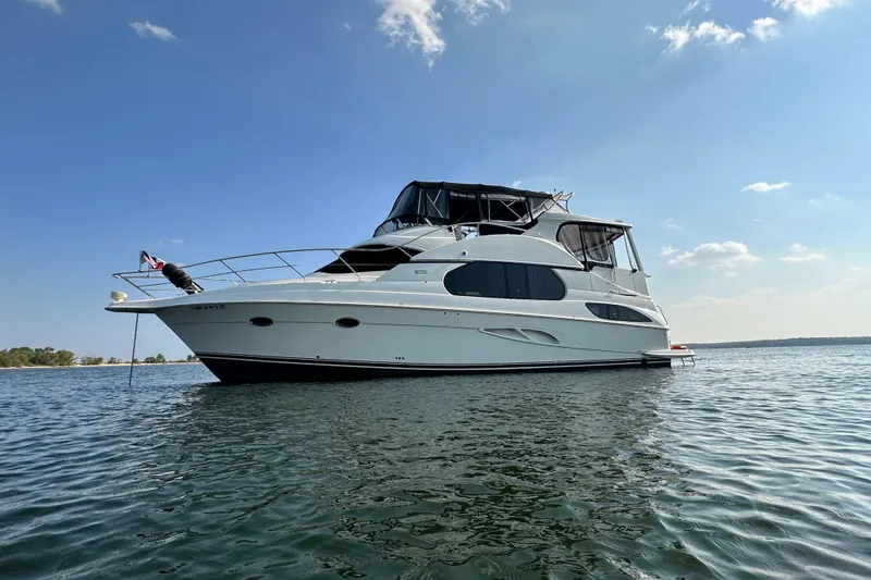Slide: The Image of 2005 Silverton 43 Motor Yacht on calm water under clear blue sky. - 7
