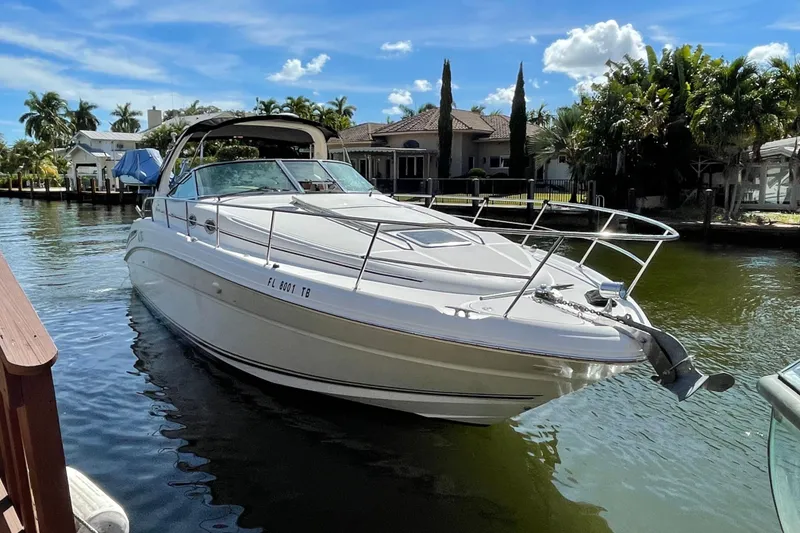 The Image of 2002 Sea Ray 360 Sundancer yacht docked in a sunny waterfront setting. - 0