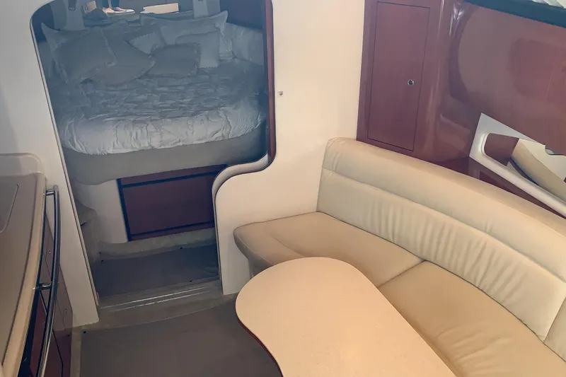 Slide: The Image of Interior of 2002 Sea Ray 360 Sundancer with cozy seating and sleeping area. - 6