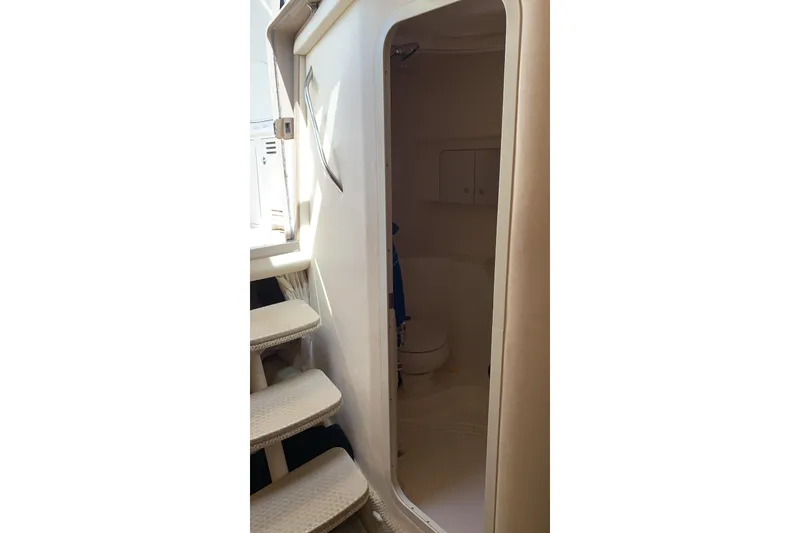 Slide: The Image of Interior view of 2002 Sea Ray 360 Sundancer bathroom with stairs and door. - 8