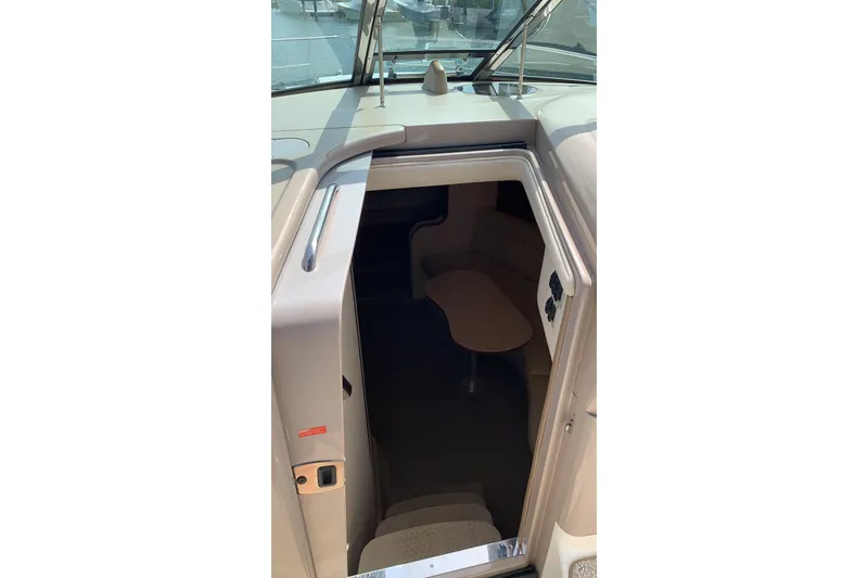 Slide: The Image of 2002 Sea Ray 360 Sundancer cabin entrance with seating and table visible. - 9