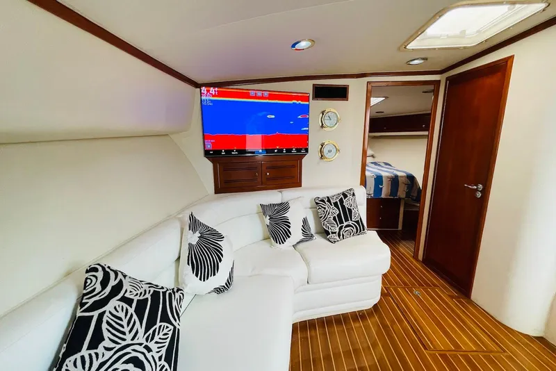 Slide: The Image of Luxurious interior of 1998 Cabo 45 Express yacht with white seating and nautical decor. - 7