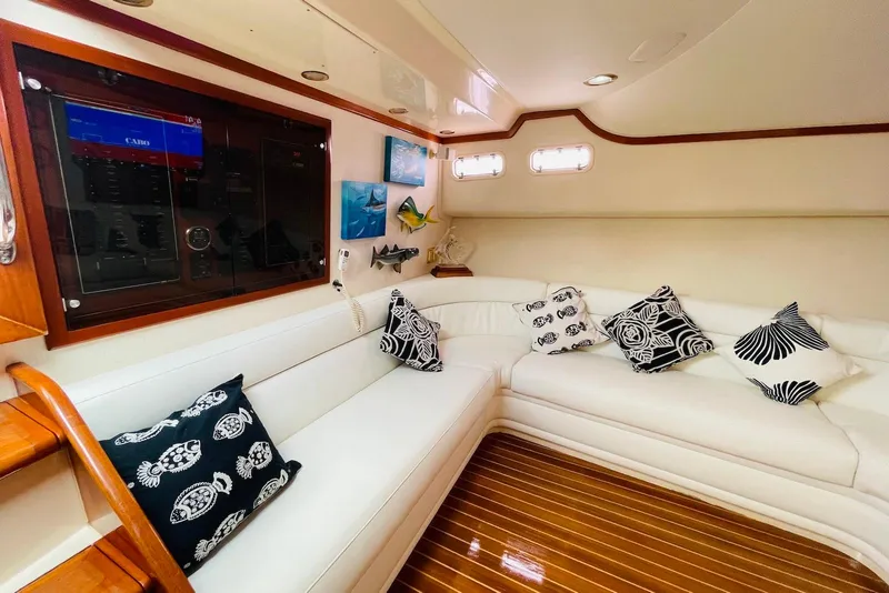 Slide: The Image of Luxurious interior of 1998 Cabo 45 Express yacht with white seating and decorative pillows. - 9
