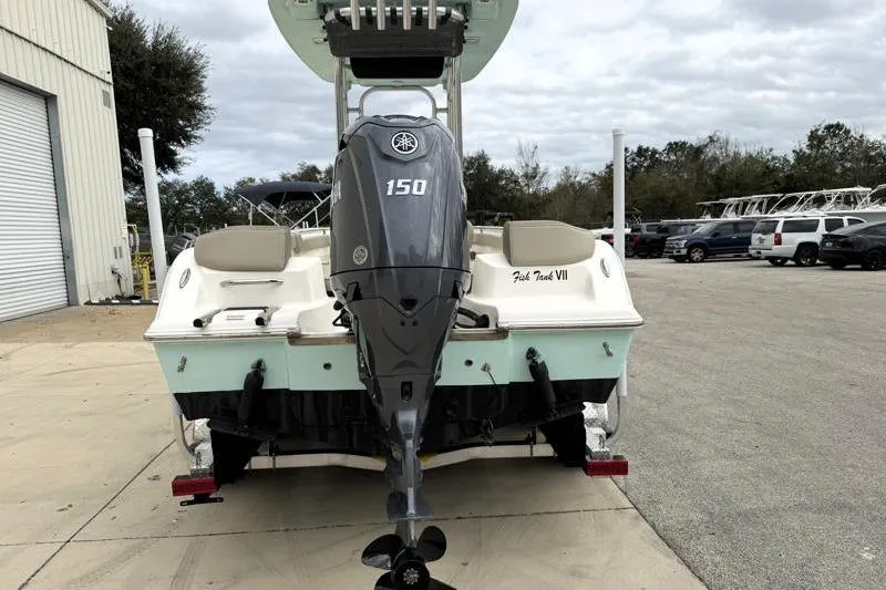 Slide: The Image of 2024 Key West 203 FS boat with Yamaha 150 engine, parked outdoors. - 10