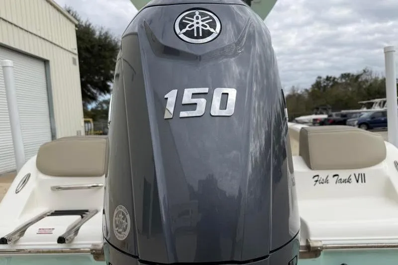 Slide: The Image of 2024 Key West 203 FS boat with Yamaha 150 outboard motor, docked outdoors. - 13