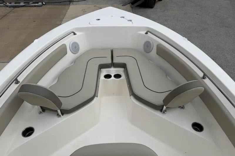 Slide: The Image of 2024 Key West 203 FS boat interior with cushioned seating and cup holders. - 16