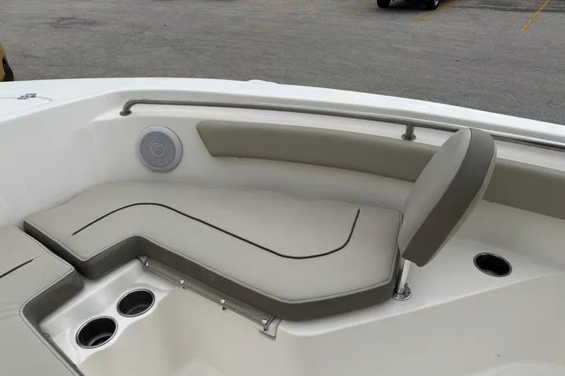Slide: The Image of 2024 Key West 203 FS boat interior with cushioned seating and cup holders. - 17