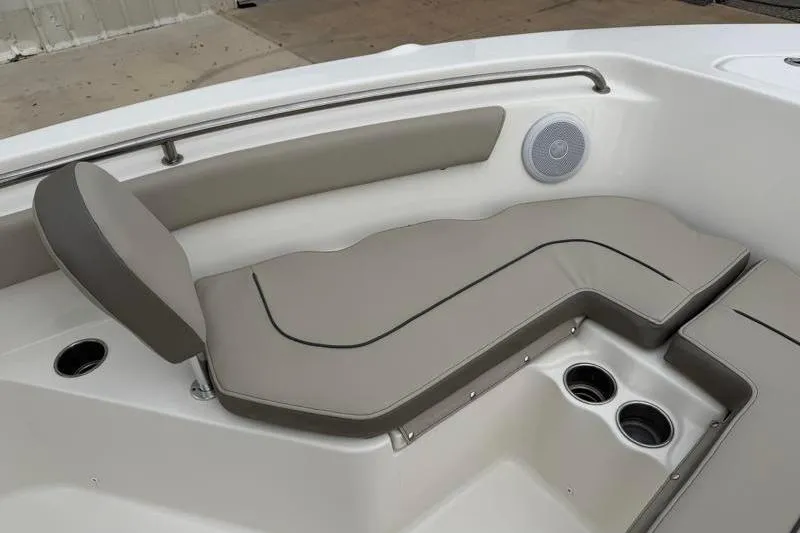 Slide: The Image of 2024 Key West 203 FS boat interior with cushioned seating and cup holders. - 18
