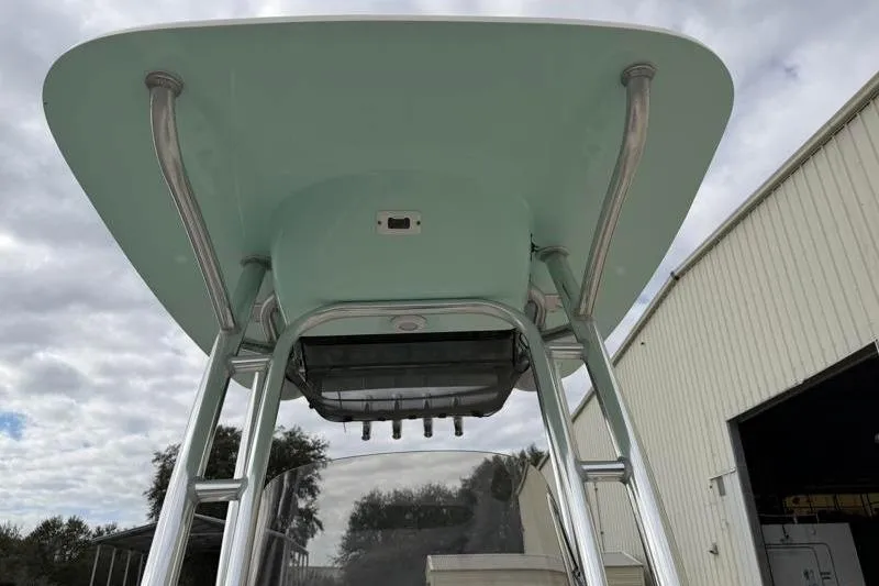 Slide: The Image of 2024 Key West 203 FS boat T-top with rod holders, under cloudy sky. - 21