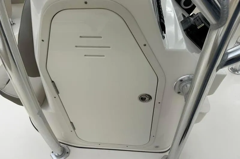 Slide: The Image of 2024 Key West 203 FS boat console with storage compartment and stainless steel railing. - 24