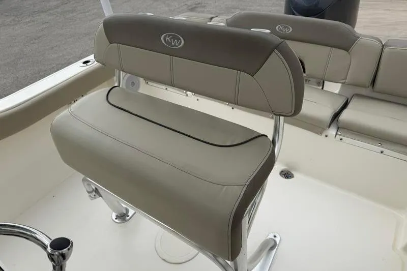 Slide: The Image of 2024 Key West 203 FS boat seating with beige upholstery and stainless steel frame. - 26