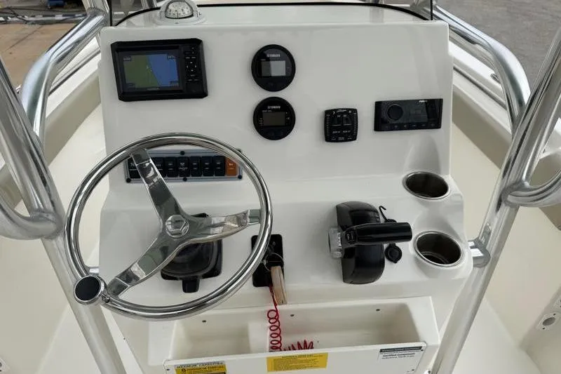 Slide: The Image of 2024 Key West 203 FS boat console with steering wheel and navigation instruments. - 27