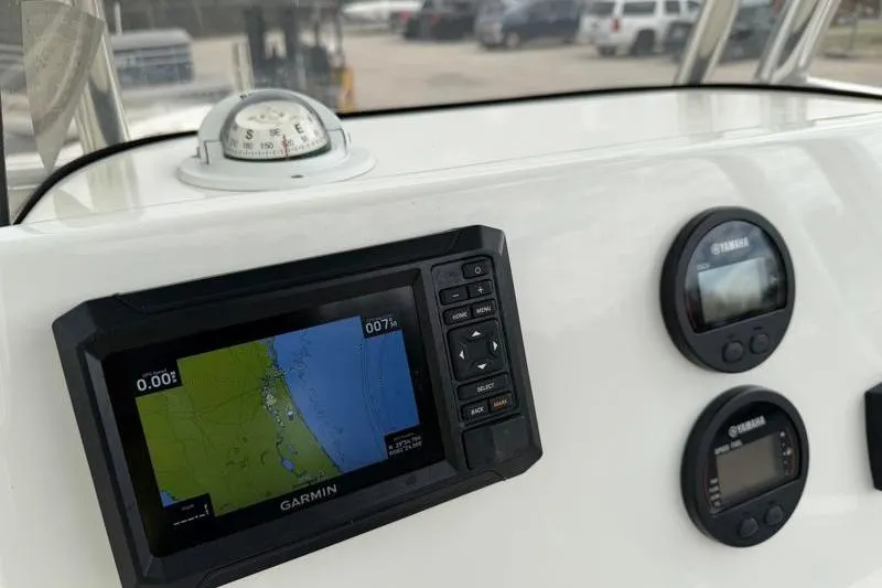 Slide: The Image of 2024 Key West 203 FS boat dashboard with Garmin navigation and Yamaha gauges. - 28