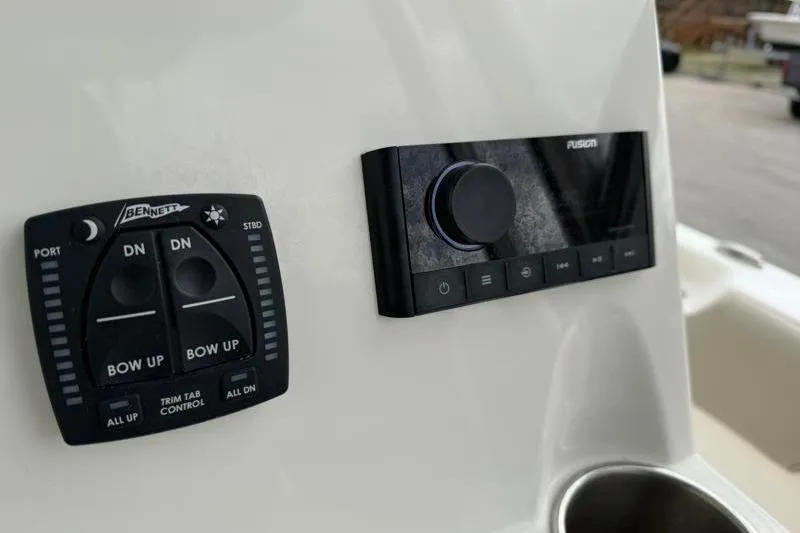 Slide: The Image of 2024 Key West 203 FS boat controls featuring Bennett trim tab and Fusion audio system. - 29