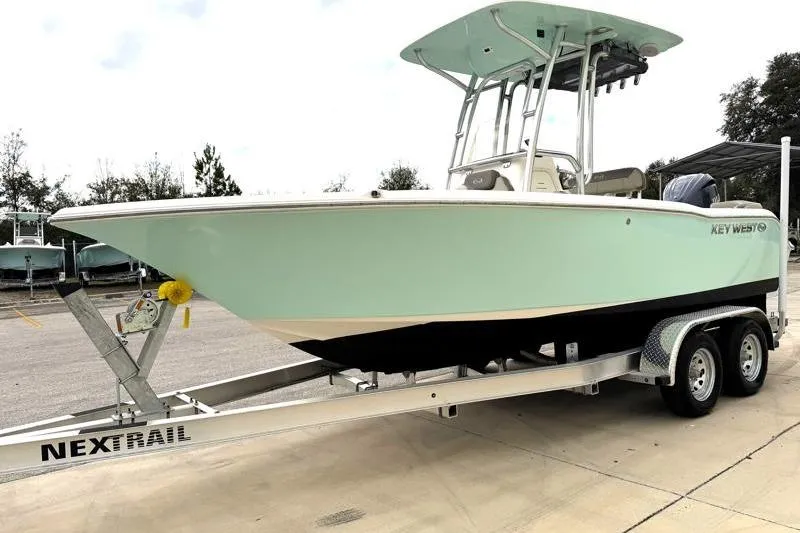 Slide: The Image of 2024 Key West 203 FS boat on trailer, light green hull, outdoor display. - 3