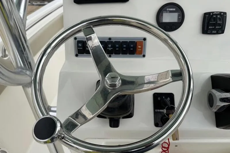 Slide: The Image of Steering wheel and controls of 2024 Key West 203 FS boat dashboard. - 31