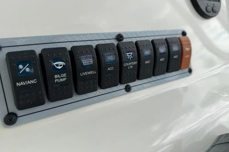 Slide: The Image of Control panel of 2024 Key West 203 FS boat with labeled switches. - 32