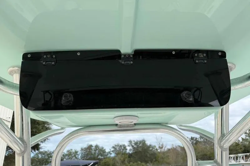 Slide: The Image of 2024 Key West 203 FS boat's T-top underside with black panel and metal supports. - 33