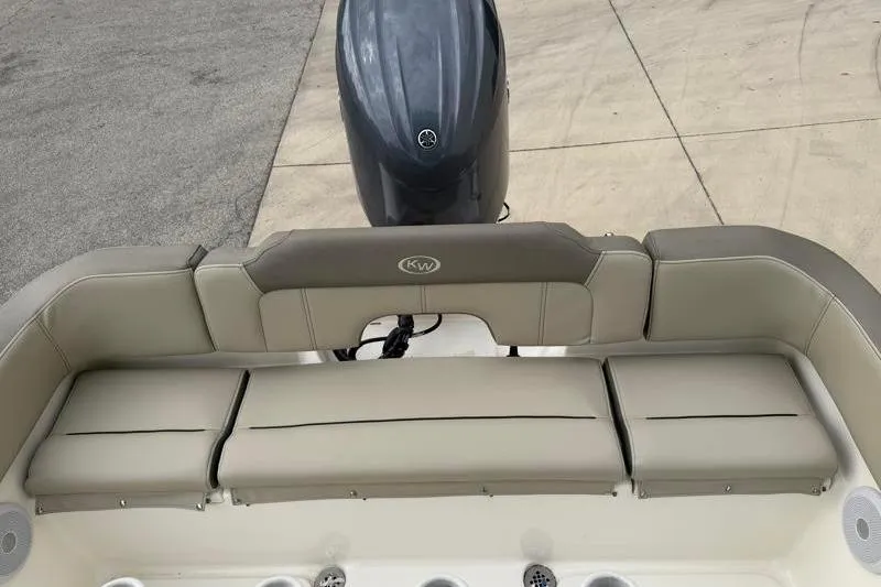 Slide: The Image of 2024 Key West 203 FS boat interior with cushioned seating and outboard motor. - 36