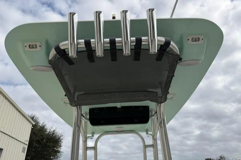 Slide: The Image of 2024 Key West 203 FS boat T-top with rod holders against cloudy sky. - 38