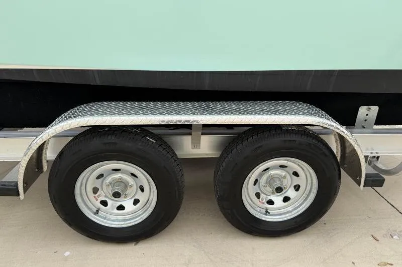 Slide: The Image of 2024 Key West 203 FS boat trailer with dual wheels and metal fender. - 44