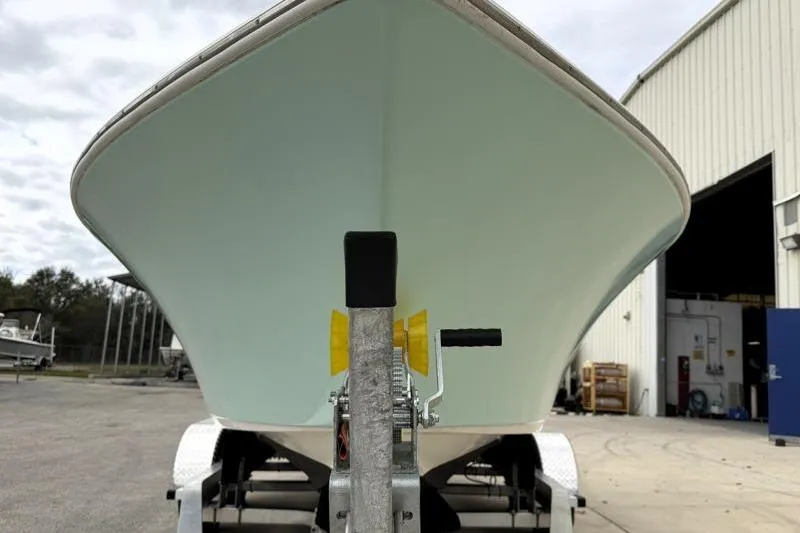 Slide: The Image of 2024 Key West 203 FS boat on trailer outside a warehouse. - 7