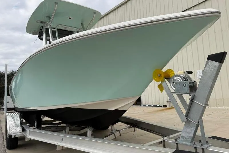 Slide: The Image of 2024 Key West 203 FS boat on trailer, light blue hull, parked outdoors. - 8