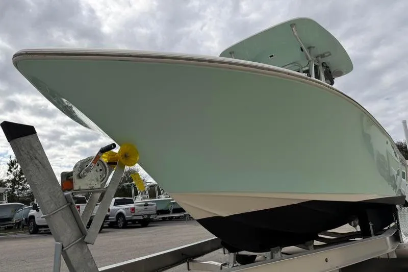 Slide: The Image of 2024 Key West 203 FS boat on trailer under cloudy sky. - 9