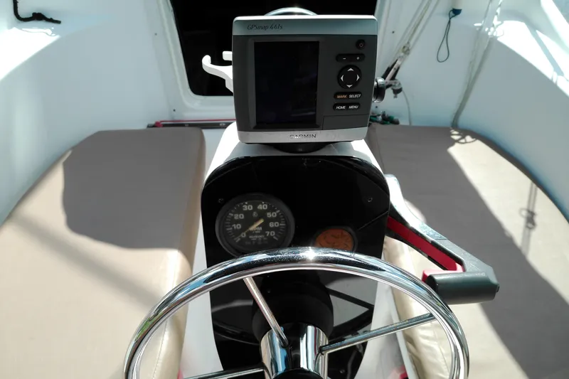 Slide: The Image of Steering wheel and GPS on 2011 MacGregor 26M sailboat cockpit. - 14