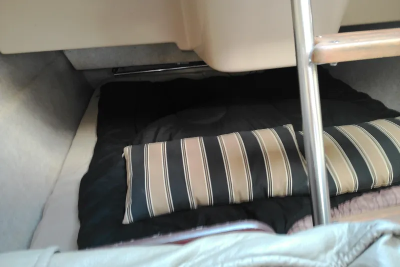 Slide: The Image of Cozy interior cabin of 2011 MacGregor 26M sailboat with striped cushions. - 20