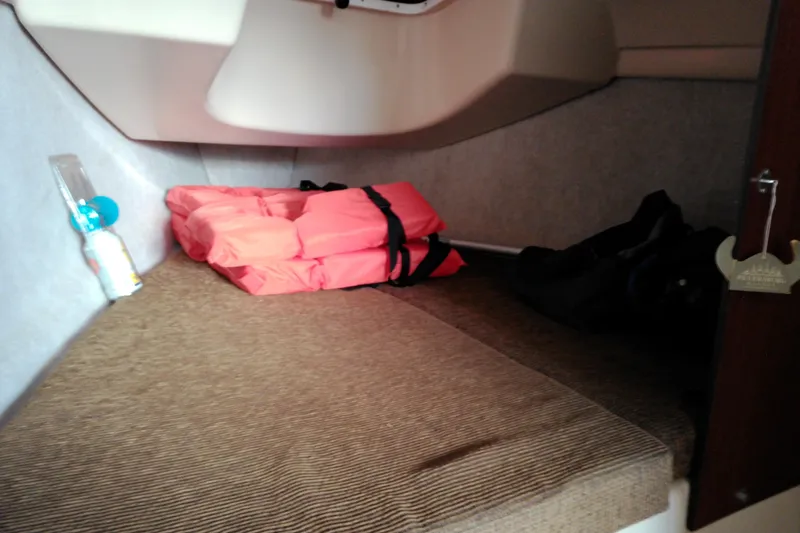 Slide: The Image of Interior cabin of 2011 MacGregor 26M with life jacket and bottle. - 25