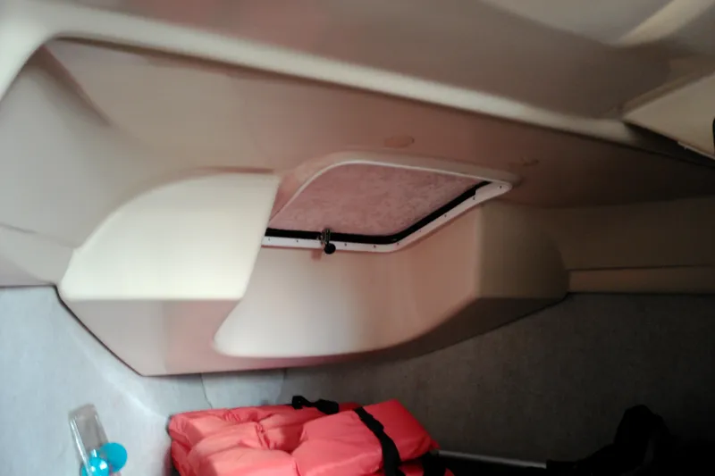 Slide: The Image of Interior cabin of a 2011 MacGregor 26M sailboat with life jackets stored. - 26