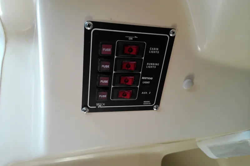 Slide: The Image of Control panel on 2011 MacGregor 26M boat with labeled switches and fuses. - 34