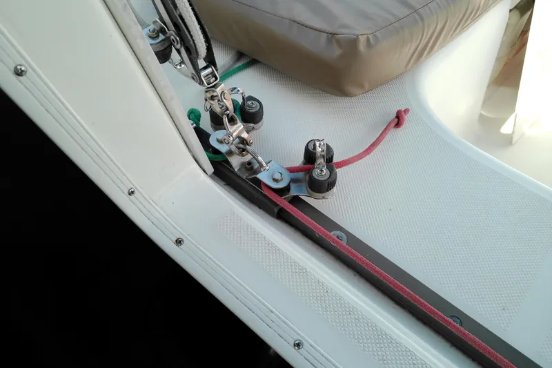 Slide: The Image of Close-up of 2011 MacGregor 26M sailboat deck with rigging and red rope. - 35