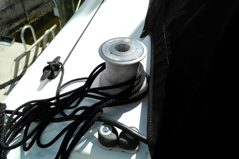 Slide: The Image of Deck of 2011 MacGregor 26M sailboat with cleat and rope detail. - 37