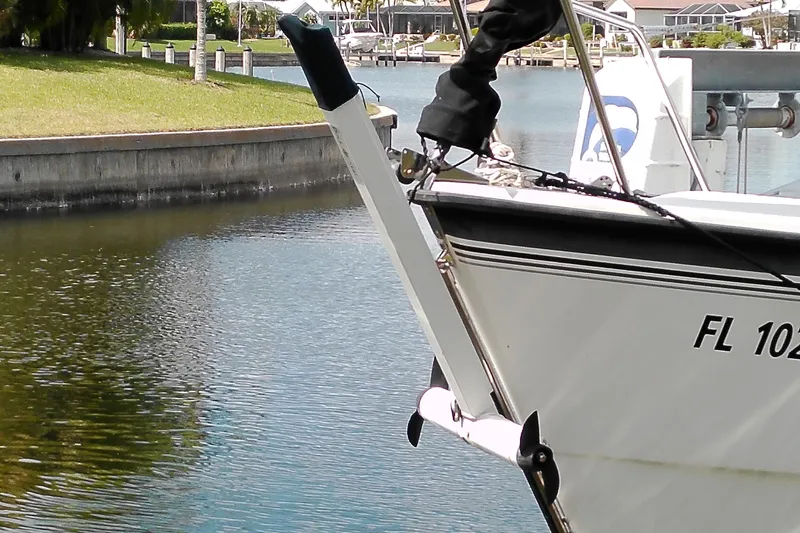 Slide: The Image of 2011 MacGregor 26M sailboat docked in a calm marina setting. - 4