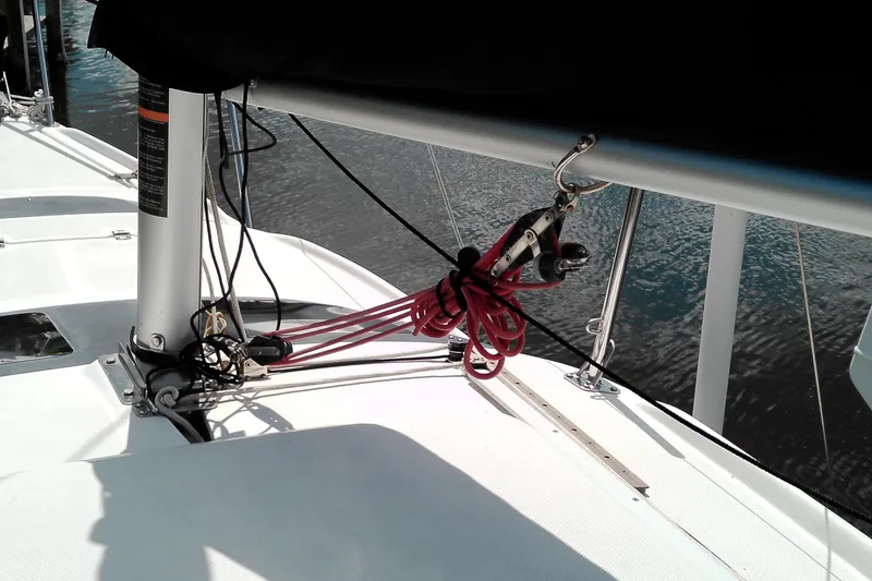 Slide: The Image of 2011 MacGregor 26M sailboat deck with rigging and red ropes. - 6