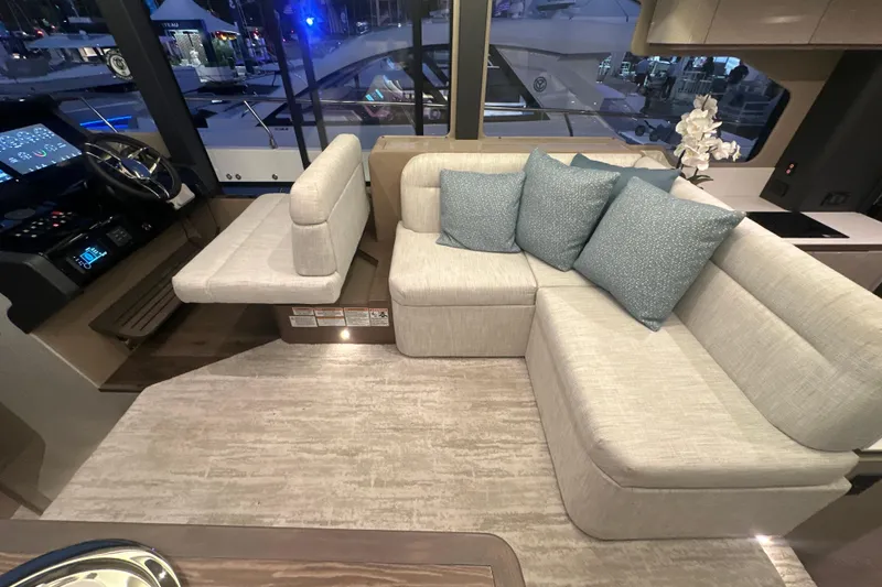 Slide: The Image of Luxurious interior of 2026 Cruisers Yachts 50 Fly with plush seating and modern helm. - 12