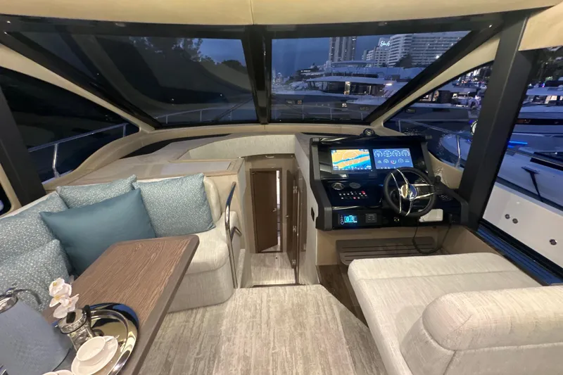 Slide: The Image of Luxurious interior of 2026 Cruisers Yachts 50 Fly with modern helm and seating area. - 14